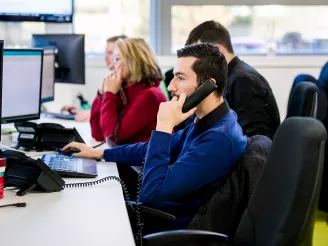 Helpdesk professional on telephone call with client