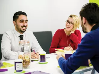 Three people having a team meeting