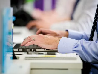 Close up of hands typing on a keyboard