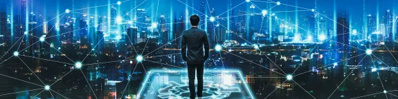 Business man looks out across a virtual city skyline - cloud technology is everywhere