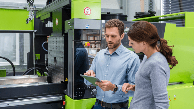 Colleagues controlling machinery with a tablet